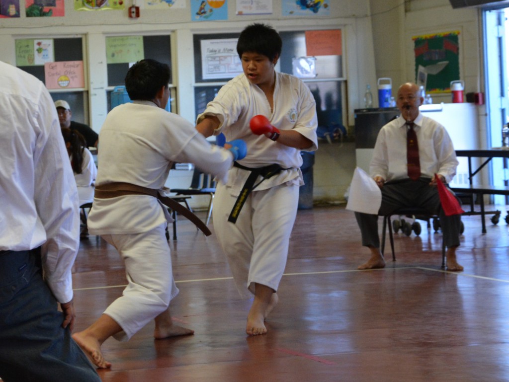 Brody Yamada versus Michael Doan with JKA Hawaii Chief Instructor Sensei Hiro Maeda during a match