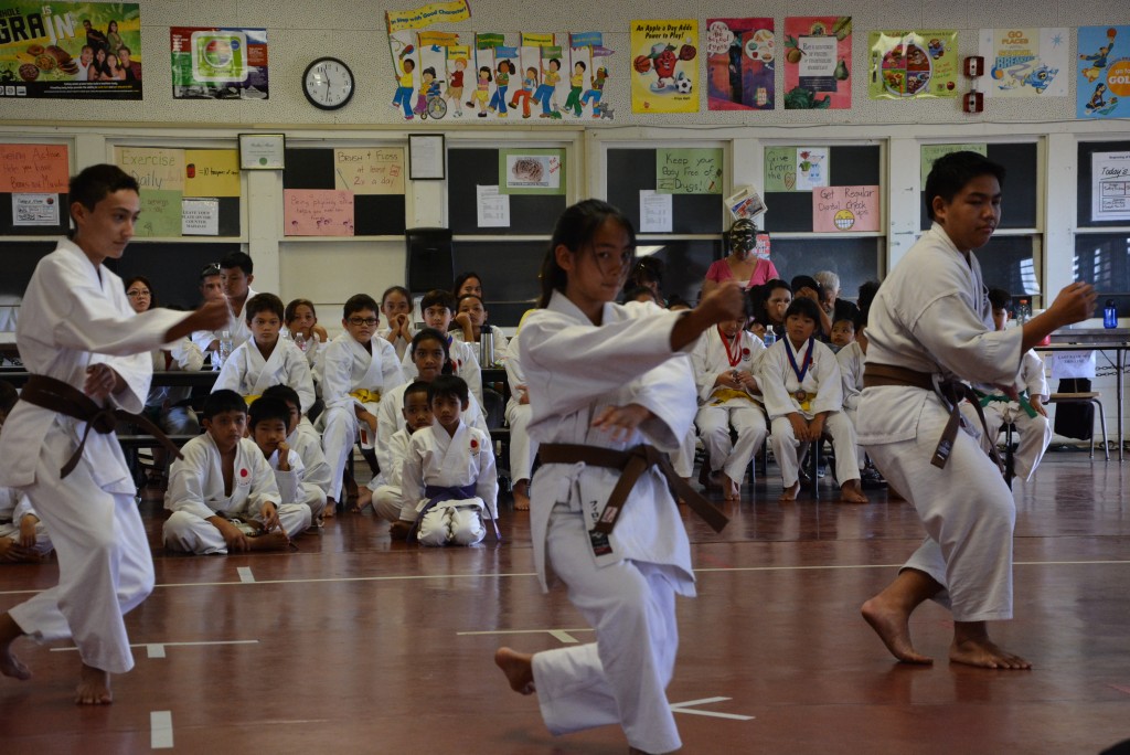 Jaden Texeira, Kelsi Fillon and Brody Yamada during the Team Kata category, here performing Bassai Dai.